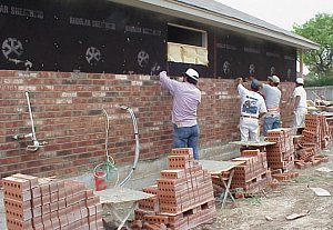 A team working to lay the bricks.
