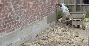 Once the concrete workers have completed the flatwork, they apply a coating to the sides of the foundation to smooth and improve the appearance. 