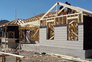 A picture of the back of the house.  The workers have started to apply siding to the back wall.