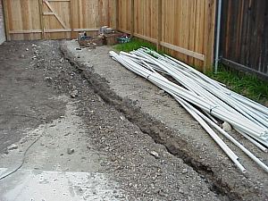 This picture shows a trench that has been made for the sprinkler system.