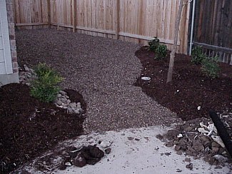 A smaller, more decorative rock was used for the area on the side of the house.  The plans were followed closely and the rock was placed using curves rather than straight lines to create a more interesting effect.